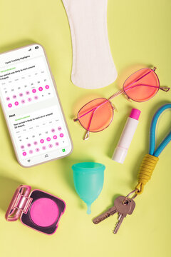Period tracking and feminine products on vibrant surface