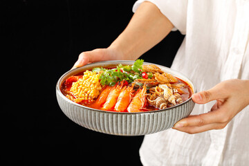 Asian Seafood Hot Pot with Fresh Shrimp Corn and Vegetables in Traditional Ceramic Bowl