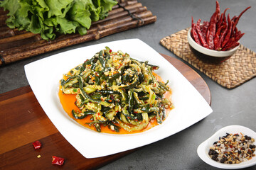 Cold cucumber strips with spicy garlic sauce and dried chili peppers Asian salad dish