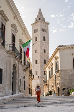 Woman exploring historic architecture in Trani, Italy