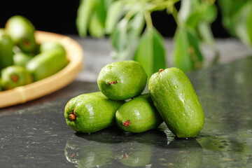 Fresh Green Kiwi Berries with Water Droplets on Dark Surface - Healthy Exotic Fruit Photography