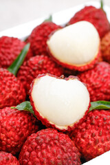Fresh Lychee Fruits with Red Textured Skin and White Flesh Exposed - Exotic Tropical Fruit Close-up