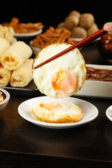Deep fried egg roll with runny yolk revealed, Asian cuisine appetizers with spring rolls and dipping sauce