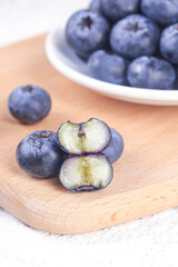 Fresh Blueberries with Sliced Berry on Wooden Board - Healthy Superfood Ingredients