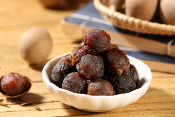 Dried Longan Fruits with Cinnamon Spice Display on Wooden Table - Traditional Asian Dried Fruits Arrangement