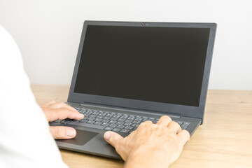 Male hands on the laptop with a black screen for your text