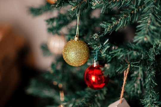Sparkling Christmas ornaments hanging on tree branches