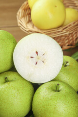 Fresh Green Pears with Sliced Cross-Section Showing White Flesh and Seeds, Organic Fruit Display