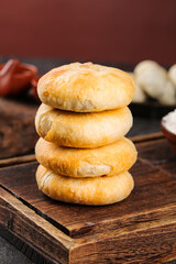 Traditional Chinese Mooncakes Stacked on Wooden Board for Mid-Autumn Festival Celebration