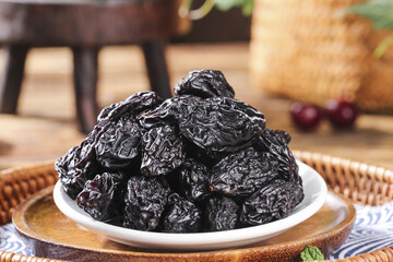 Dried Prunes in White Bowl on Wooden Base - Healthy Natural Snack Food Ingredient