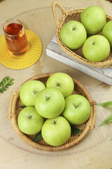 Fresh Green Pears in Wicker Baskets with Tea - Healthy Organic Fruit Still Life
