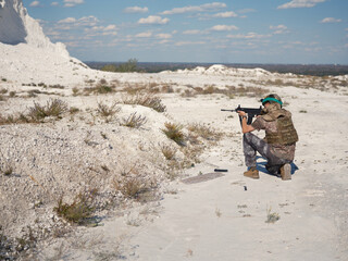 Ukrainian Soldier Kneeling and Aiming in a Chalk Quarry