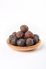 Dried Seedless Longan Fruits in Wooden Bowl on White Background