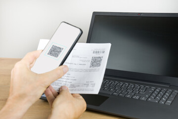 Smartphone scans QR code to pay a bill