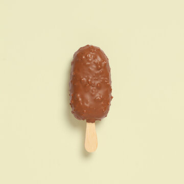 Chocolate-covered ice cream bar on a wooden stick