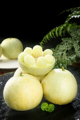 Fresh White Bitter Melon Bowls with Fern Garnish on Dark Slate - Asian Culinary Art Display