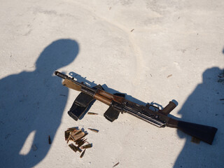 Rifle and Ammunition on Ground of Chalk Quarry