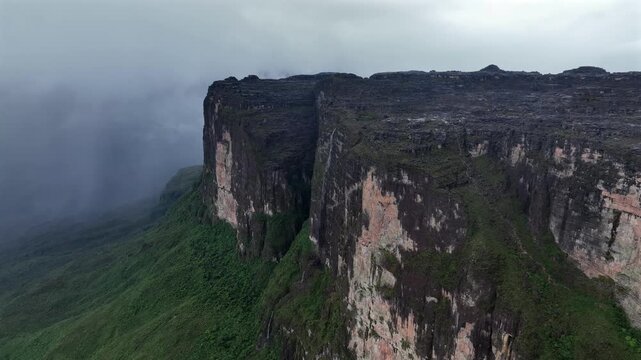 Aerial view of the majestic Roraima Mountain, its steep cliffs contrasting against the lush greenery, a stunning landscape, Paraitepui, Canaima, Venezuela.