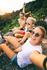 Group of young women friends traveling together in the jungle taking selfies, travel to Asia concept