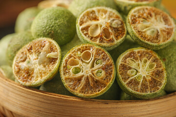 Dried Lime Slices in Wooden Bowl - Natural Citrus Fruit for Tea and Cooking