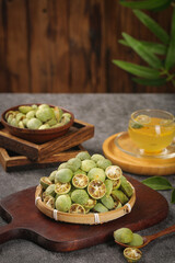 Fresh and Dried Kumquats with Herbal Tea on Wooden Boards - Healthy Citrus Fruit Snack Concept