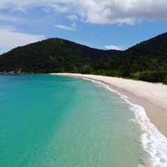 Fototapeta premium Pristine beach, lush hills, vibrant turquoise water