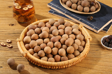 Fresh Longan Tropical Fruits in Wicker Baskets on Wooden Table with Cinnamon Tea and Dried Spices