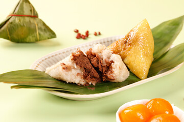 Dragon Boat Festival Zongzi Rice Dumplings with Eight Treasures Pork and Egg Yolk Filling on Bamboo Leaves