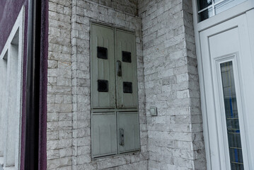 Metal utility box electricity meter install in wall outside residential building