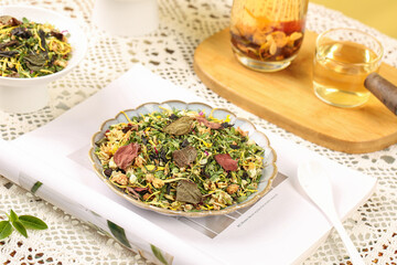 Nourishing Chinese Herbal Tea Blend with Lotus Chrysanthemum and Dendrobium on Golden Wooden Tray
