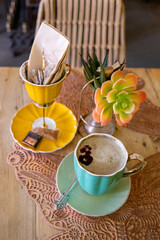 Refreshing coffee break in a cafe. Artistic shot of a cappuccino with a tiny flower
