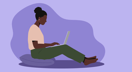 Young woman working remotely on a laptop, sitting comfortably on a cushion. Represents online business, freelance work, and modern lifestyle.
