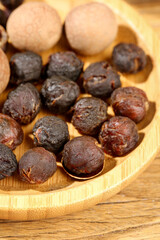 Dried Longan Fruits with Cinnamon Sticks on Bamboo Plate - Asian Superfood Ingredients Detail