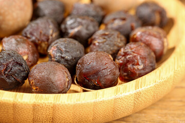 Dried Longan Fruits in Bamboo Bowl - Asian Tropical Fruit Snack Detail
