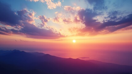 Obraz premium A breathtaking sunset over a mountain range with a vibrant sky and golden light.