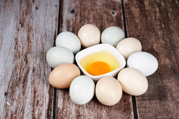 Fresh Farm Eggs with Golden Yolk on Rustic Wood Background - Natural Organic Cooking Ingredients