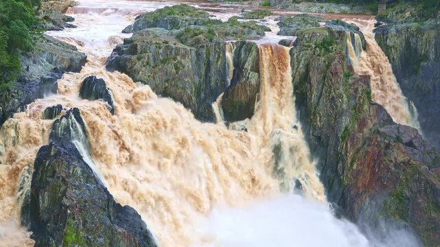Powerful Barron Falls Waterfall Flowing Through Rocky Cliffs