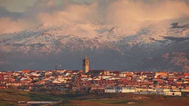 Snow-covered mountains with Colmenar Viejo town view