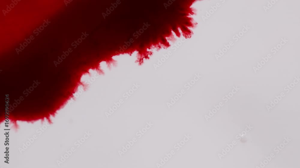 Poster red ink diffusing in water creating abstract background