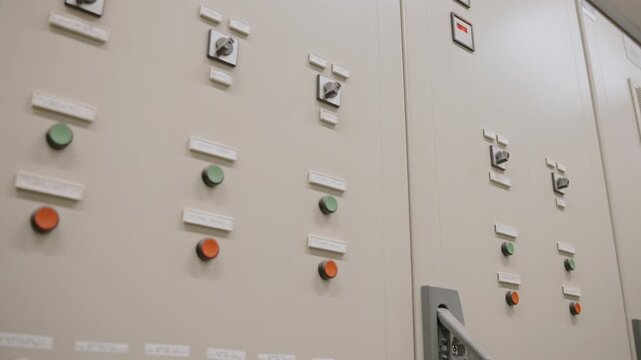 Industrial control panel with multiple buttons and switches, indoor view