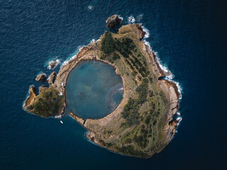 A vertical top-down view of the Islet of Vila Franca do Campo in the Azores, revealing the circular...