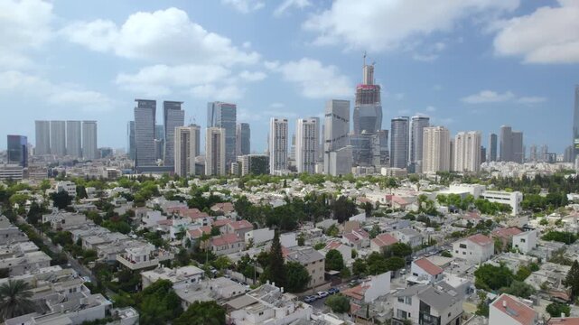 Tel Aviv skyline rooftop shot capturing Ramat Gan towers and central skyscrapers framed by urban neighborhoods beneath clear calm morning blue sky