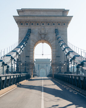 View of the magnificent Sz&Atilde;&copy;chenyi Chain Bridge, a stoic stone structure adorned with ornate carvings and suspended by robust cables, connecting the city, Budapest, Hungary.