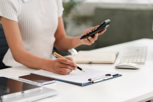 Business woman or financial data analysts working with laptop and calculator show increase market share, growth of profit investment at home office.