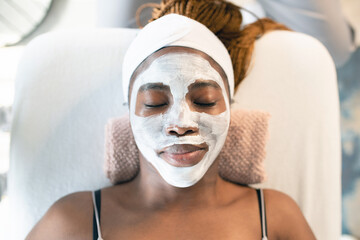 elaxed Woman Enjoying a Facial Treatment in Spa Setting