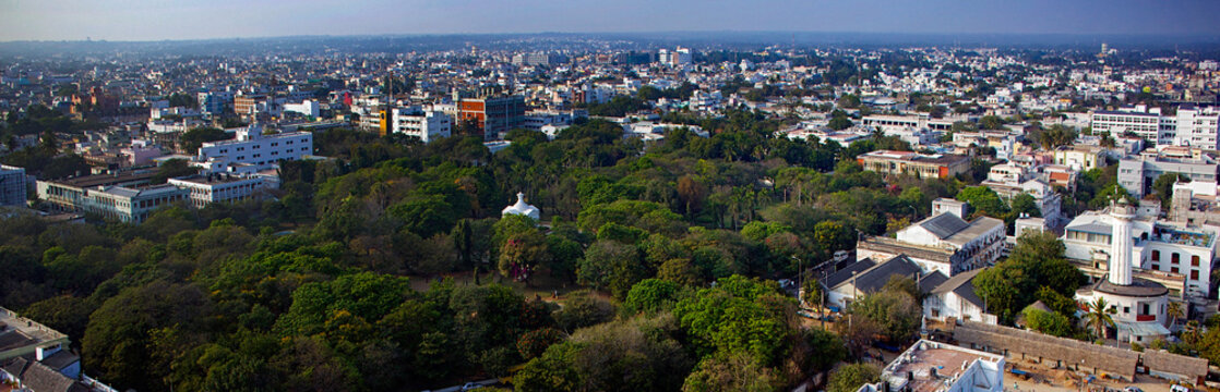Aerial view of vibrant green foliage contrasts with the urban expanse, revealing the architectural details of White Town's landscape, Puducherry, India.