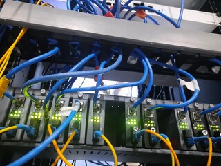 Server Rack with Blue and Yellow Ethernet Cables Connected to Switch Hub on Datacenter for Technology Internet illustration