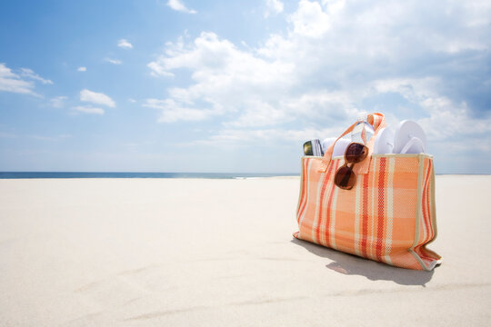 Beach bag on empty sandy beach