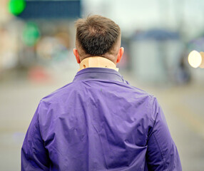 Man walking on city street wearing cervical collar, neck pain relief, orthopedic support, arthritis...