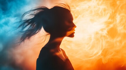 Silhouette of a woman with flowing hair against a backdrop of blue and orange smoke.